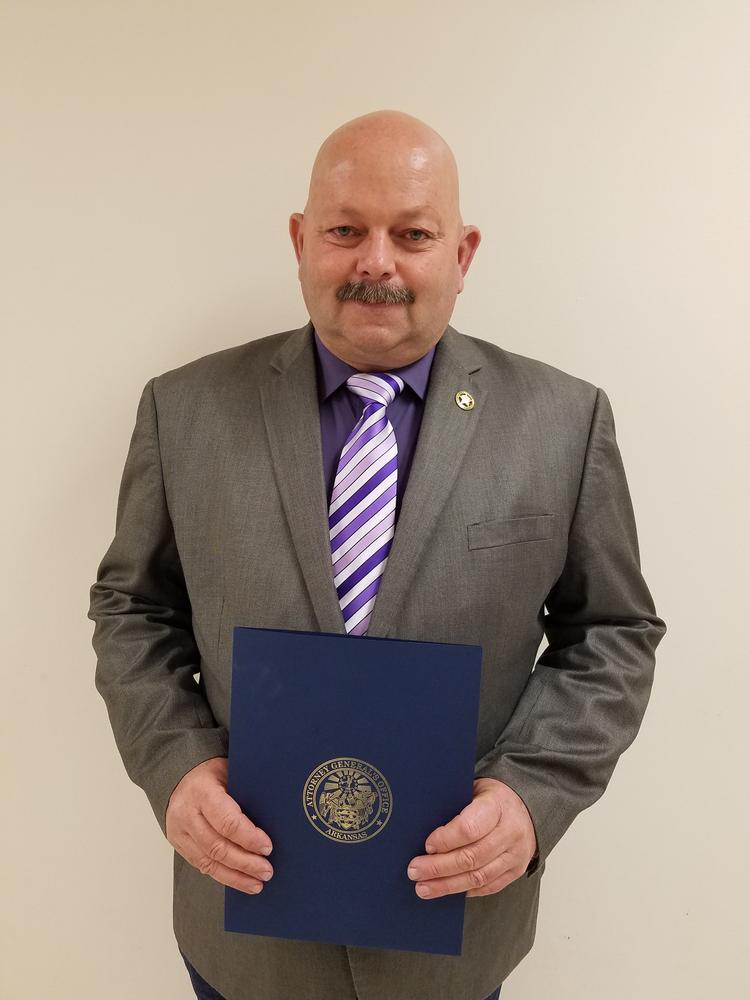 Deputy Chris Wolcott holding the Outstanding Deputy Award